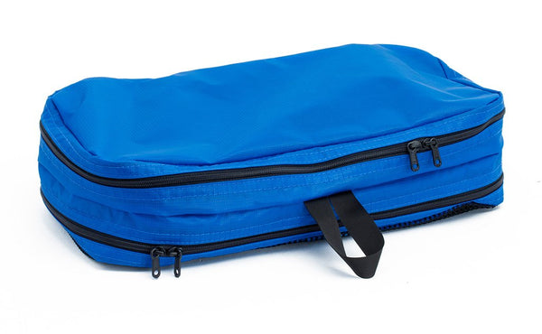 A filled and zipped closed Island (blue) Aether Small Aeronaut 45 Packing Cube all-fabric side up.